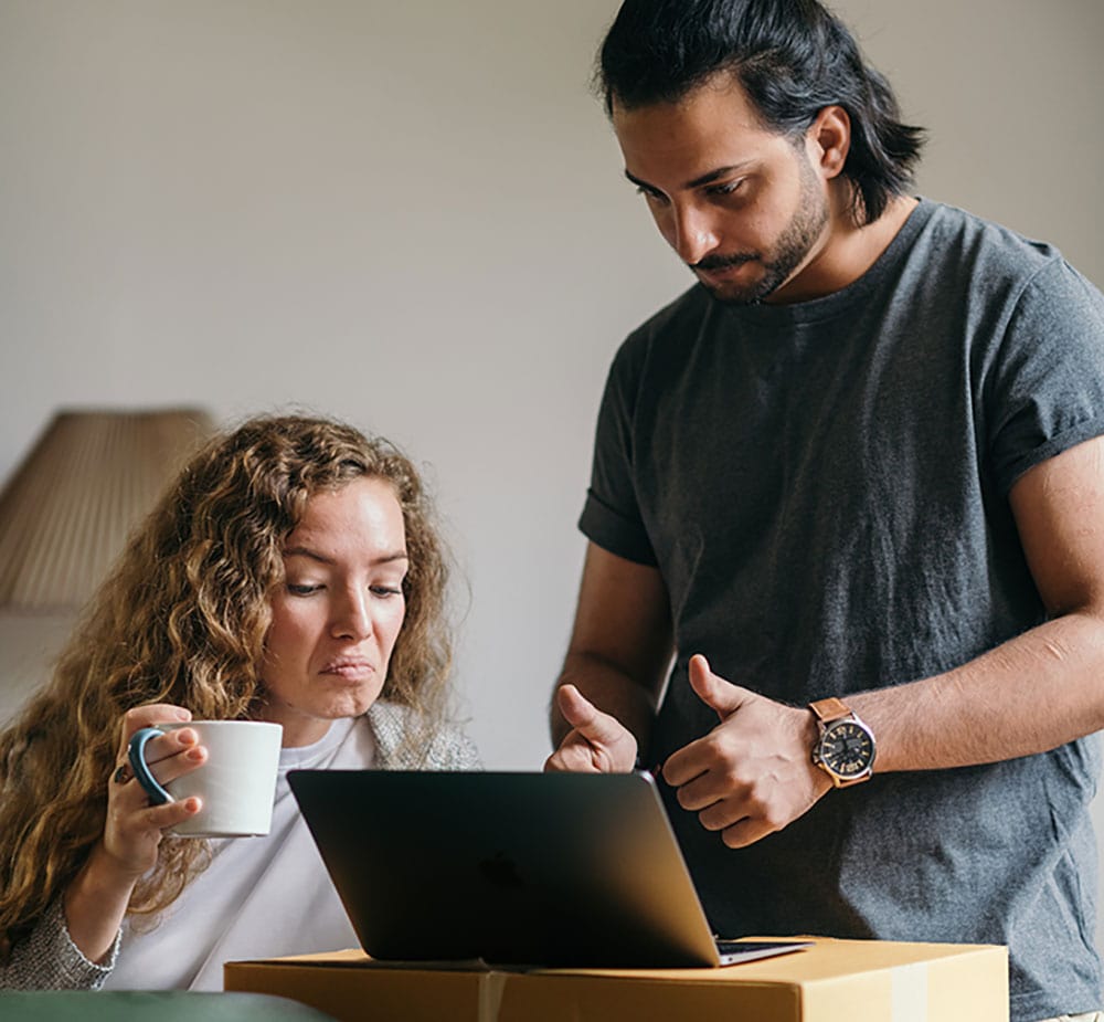 A young couple talk to their mortgage advisor on the laptop