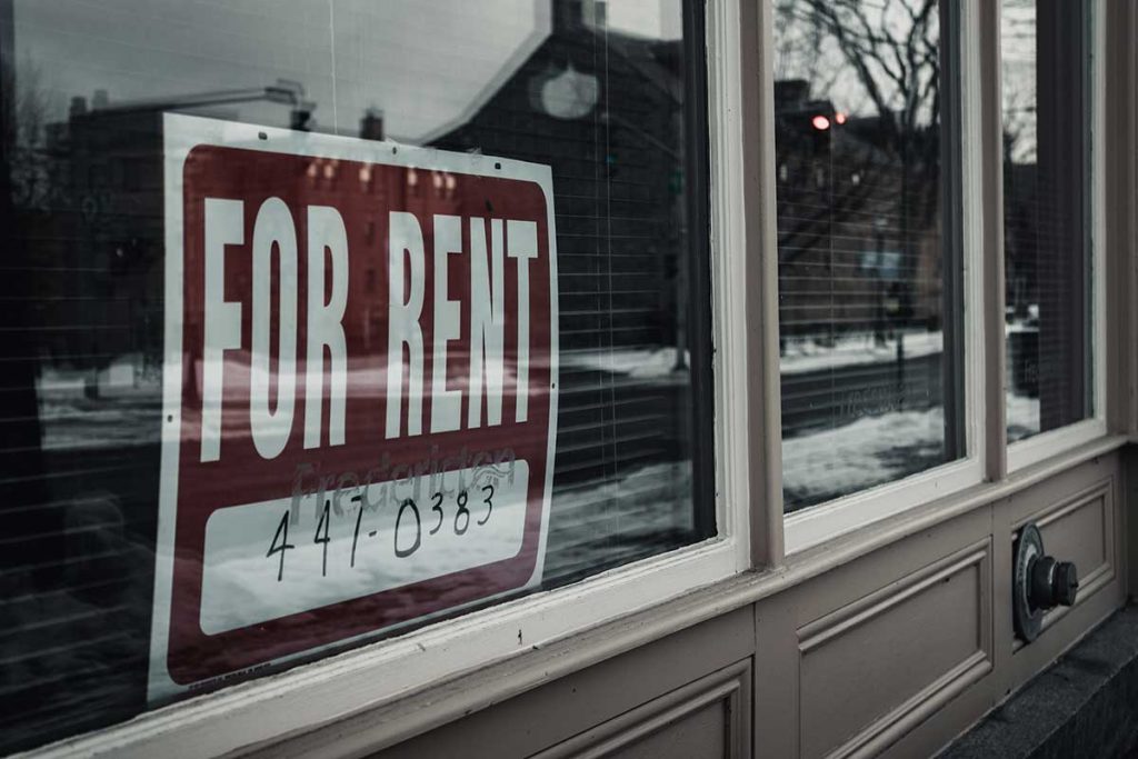 For rent sign in storefront window.